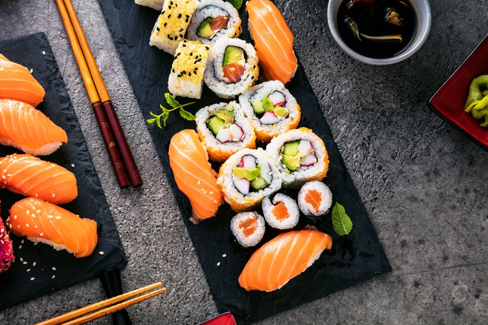 Tsim Sha Tsui Sushi apanese sushi food. Maki ands rolls with tuna, salmon, shrimp, crab and avocado. Top view of assorted sushi. Rainbow sushi roll, uramaki, hosomaki and nigiri